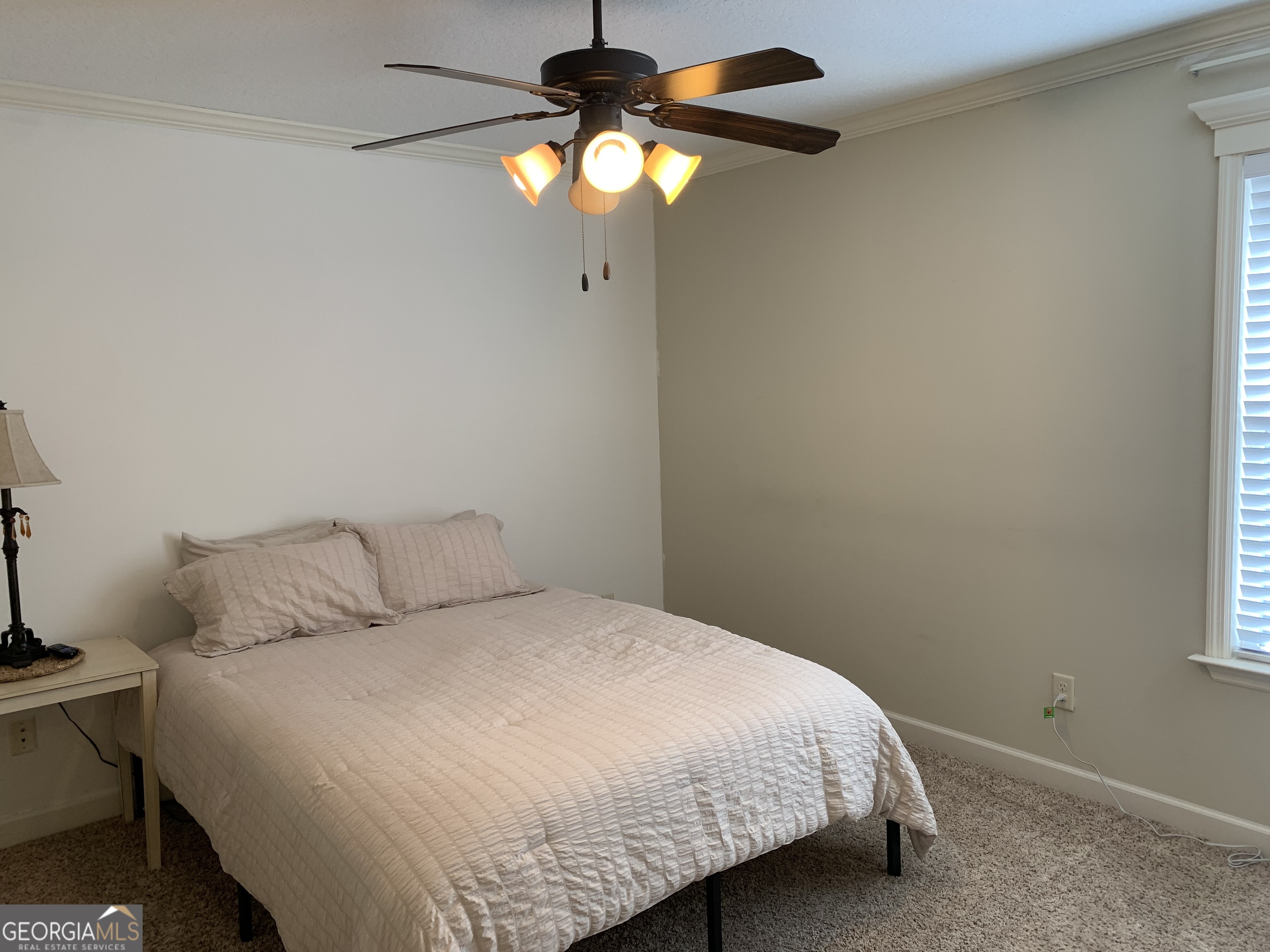 4192 Bright Creek Road Hahira, GA 31632 - Photo 22 of 28 a bedroom with a bed and a chandelier