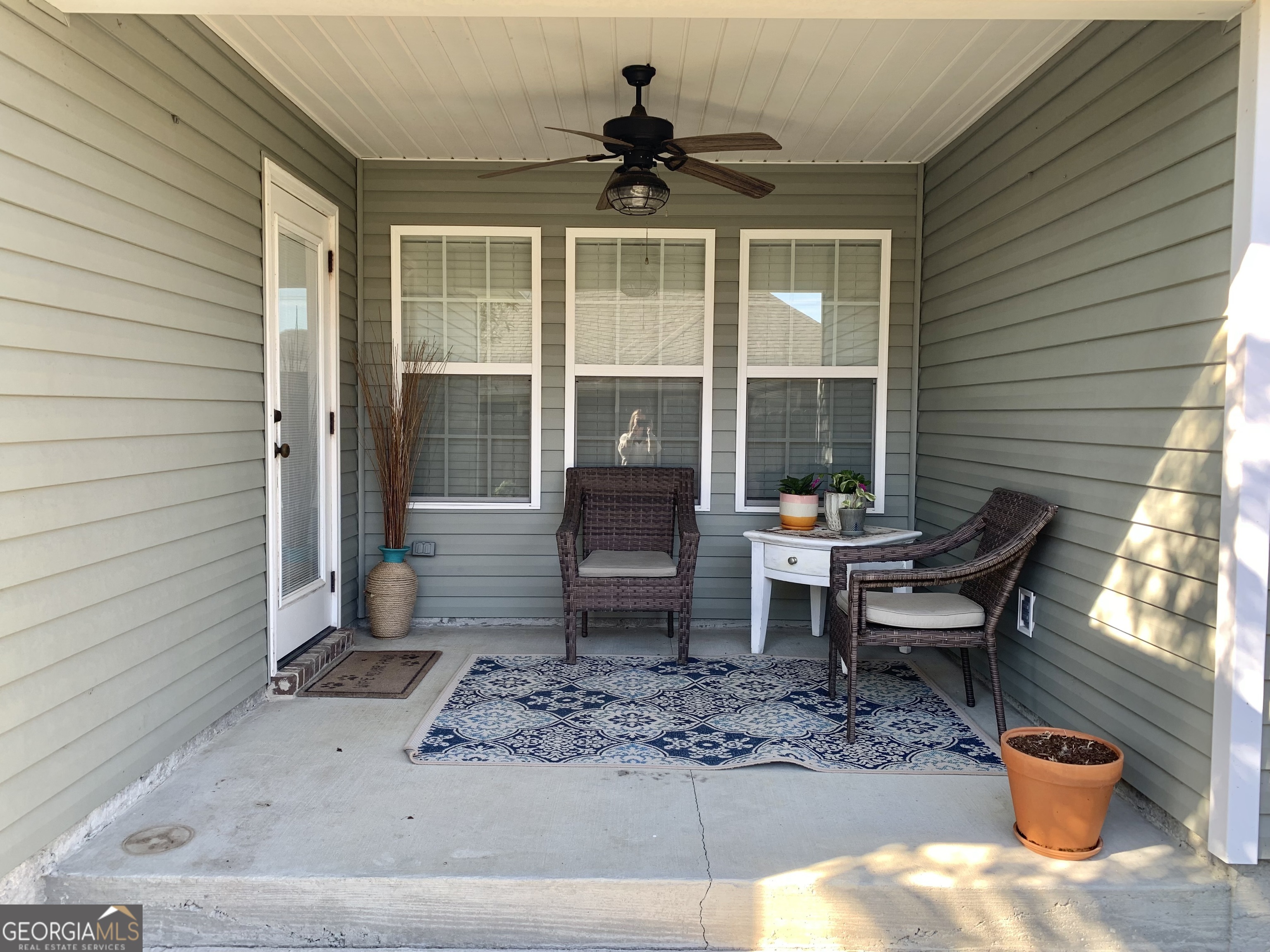 4192 Bright Creek Road Hahira, GA 31632 - Photo 28 of 28 a view of a porch with chairs and a potted plant
