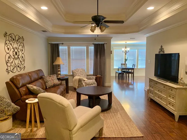 a living room with furniture and a chandelier