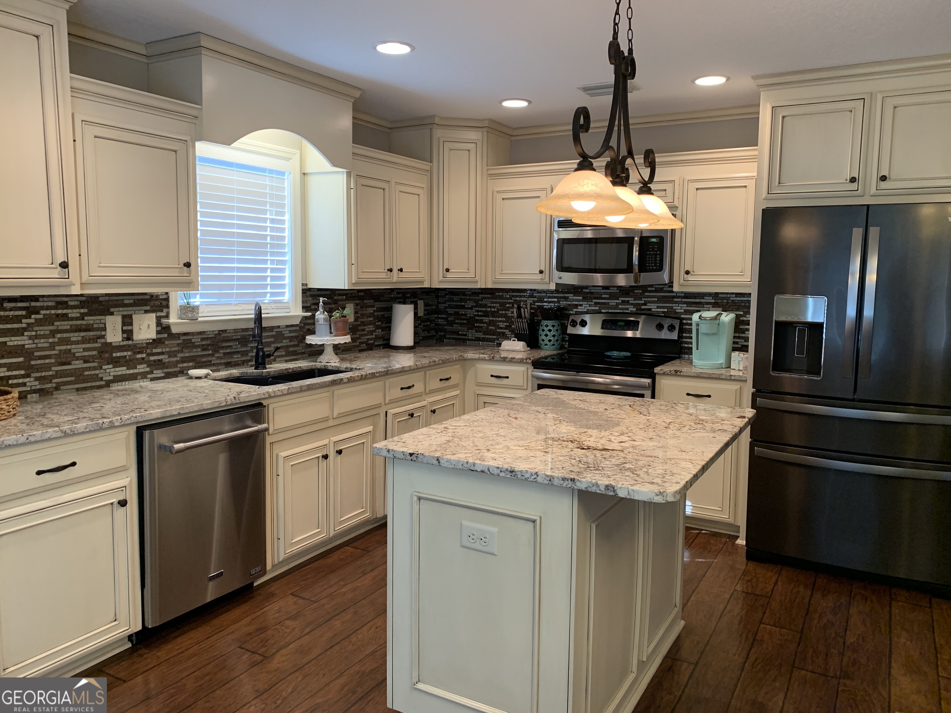 4192 Bright Creek Road Hahira, GA 31632 - Photo 10 of 28 a kitchen with stainless steel appliances granite countertop a sink a stove and a refrigerator