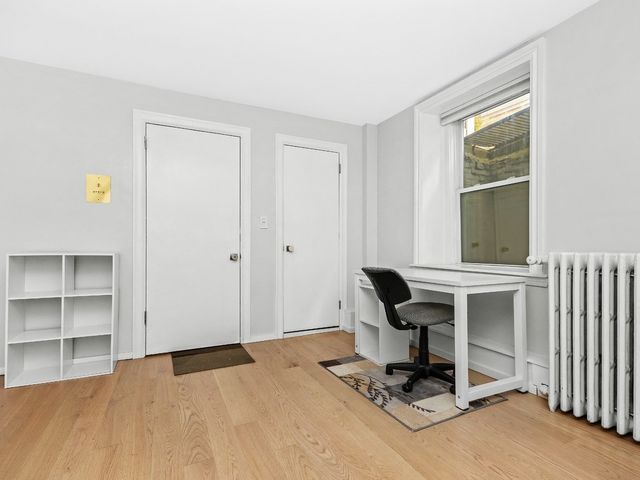 a view of workspace with wooden floor windows