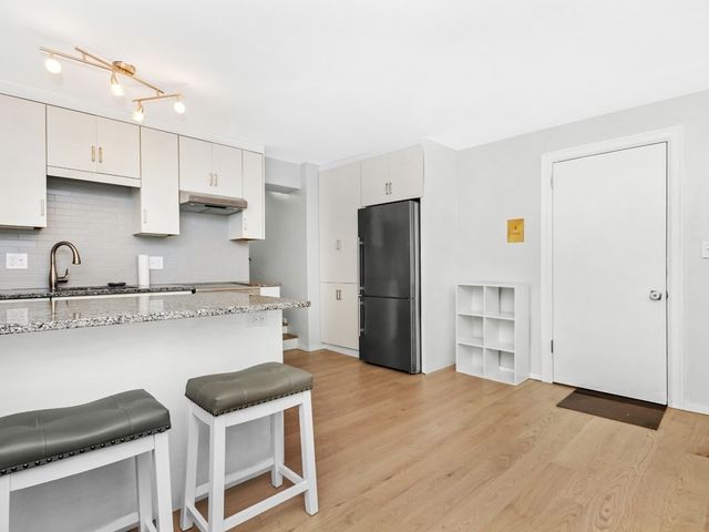 a kitchen with stainless steel appliances a sink and a refrigerator