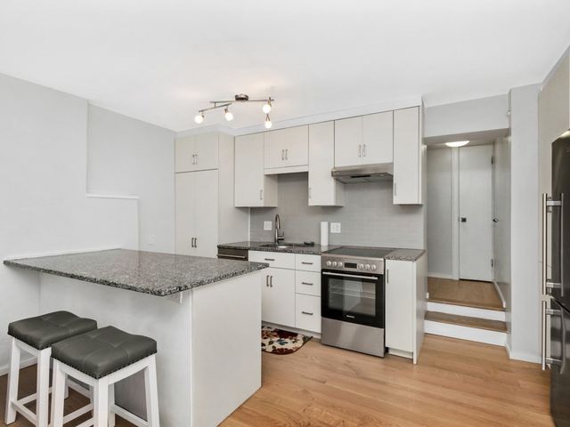 a kitchen with a stove a sink and a refrigerator