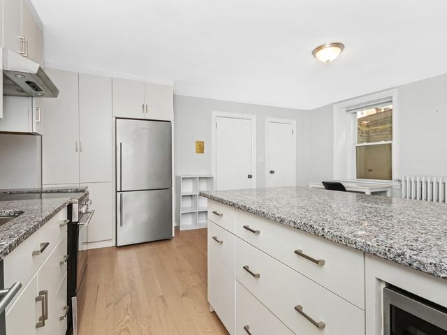a kitchen with a sink a refrigerator and a stove
