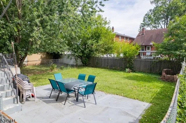 a view of backyard with seating and green space