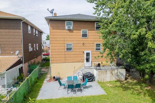 a view of a house with backyard and sitting area