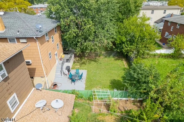 an aerial view of a house with swimming pool garden and patio