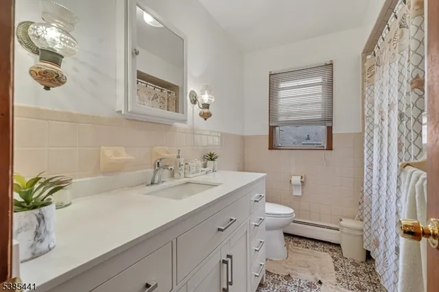 a bathroom with a sink a toilet and mirror