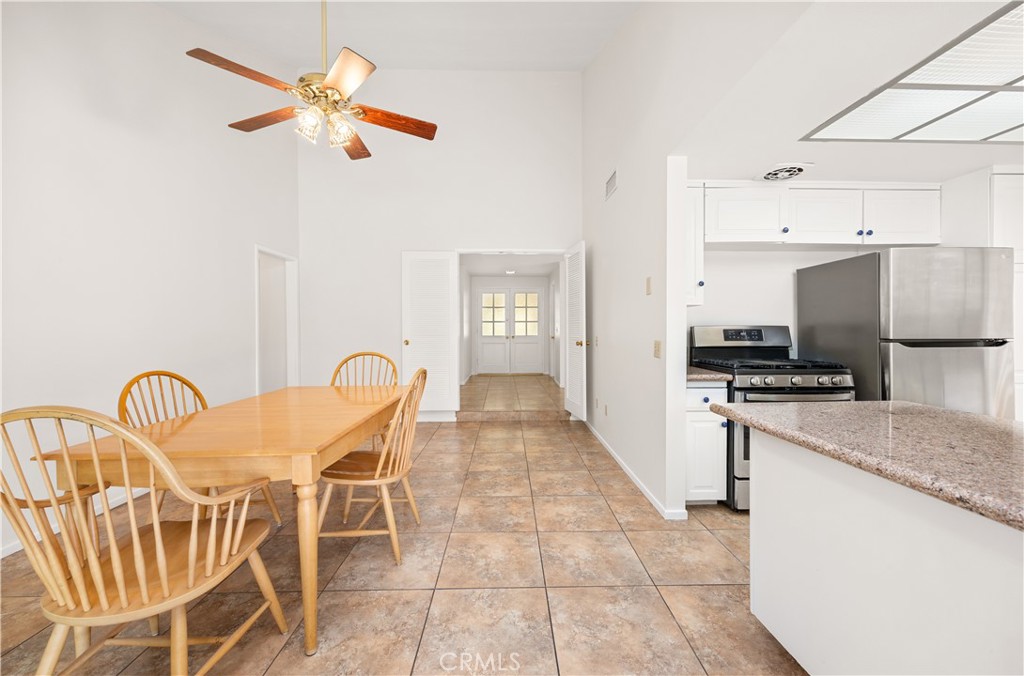 3430 Bahia Place Riverside, CA 92507 - Photo 14 of 34 a kitchen with stainless steel appliances granite countertop a table and chairs