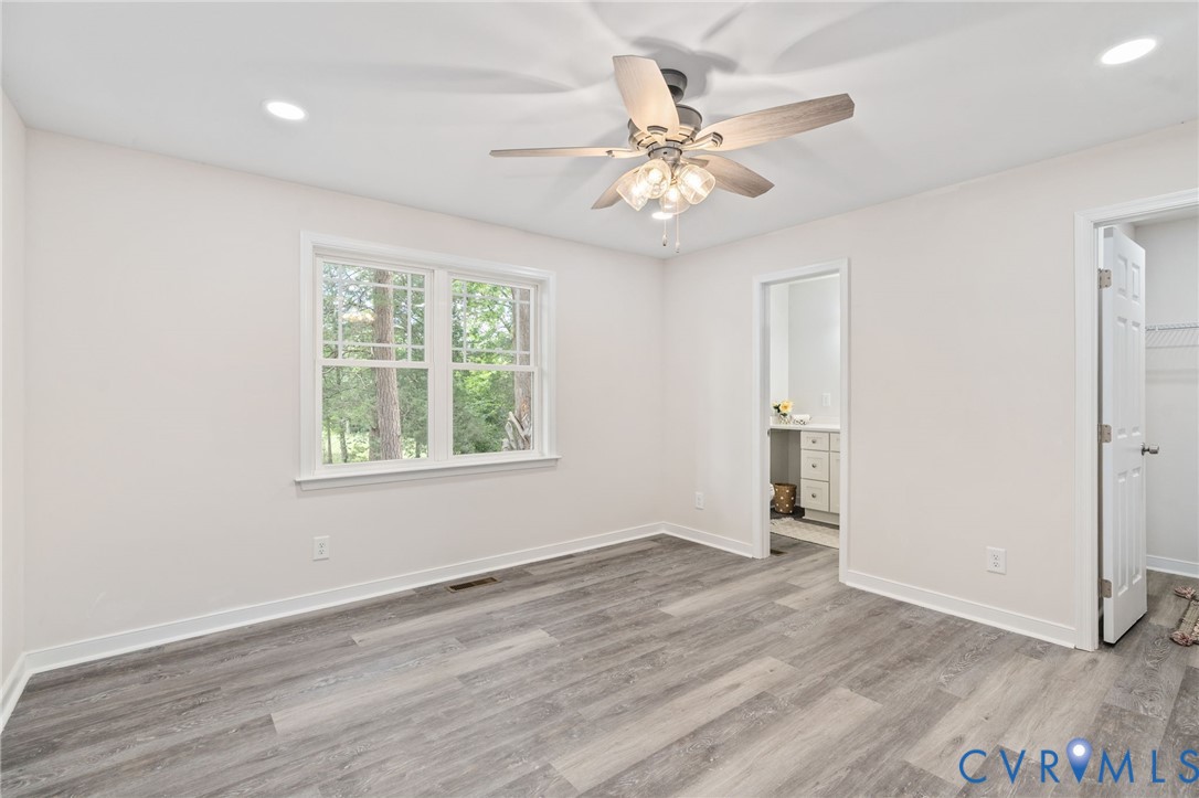 14501 Hopeful Church Road Bumpass, VA 23024 - Photo 26 of 33 a view of an empty room with wooden floor and a window