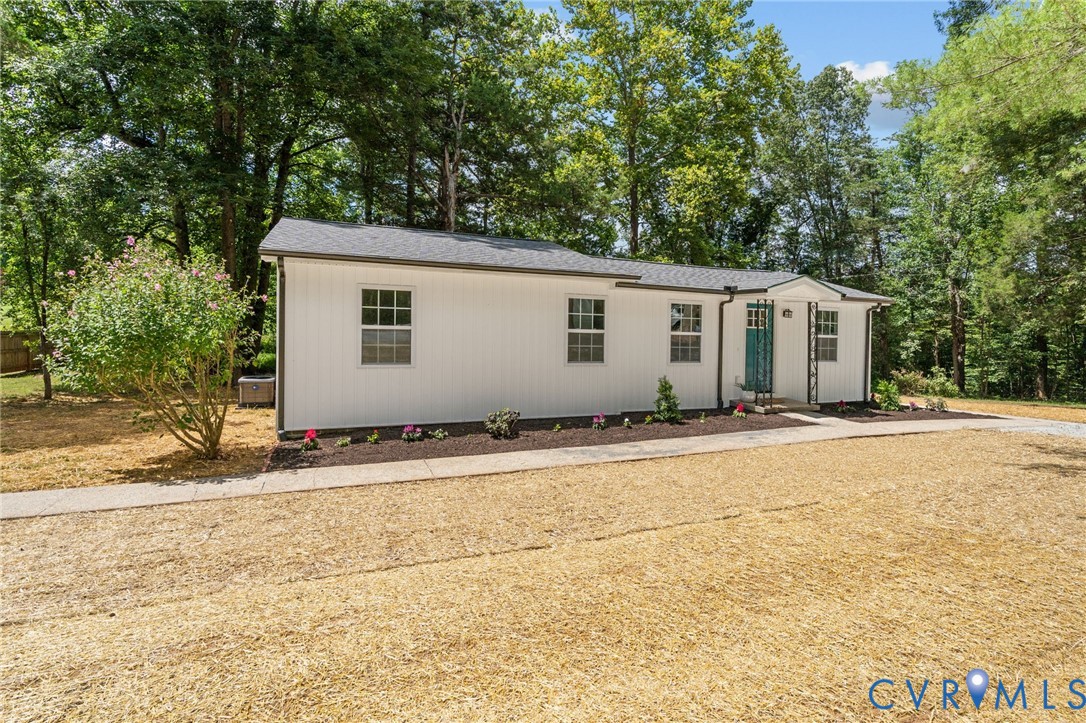 14501 Hopeful Church Road Bumpass, VA 23024 - Photo 5 of 33 a view of a white house with a yard and large trees