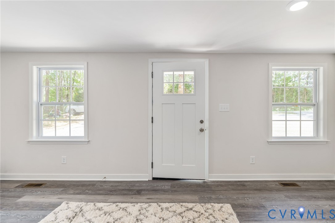 14501 Hopeful Church Road Bumpass, VA 23024 - Photo 8 of 33 an empty room with wooden floor and windows