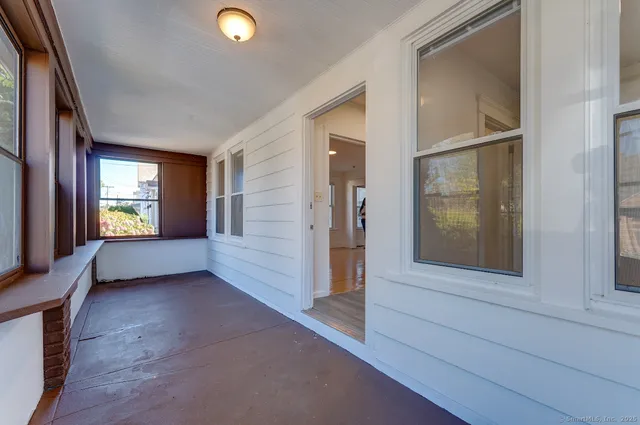 an empty room with windows and entrance