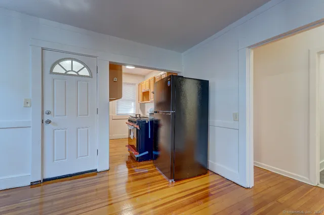 a view of a livingroom with wooden floor and a window