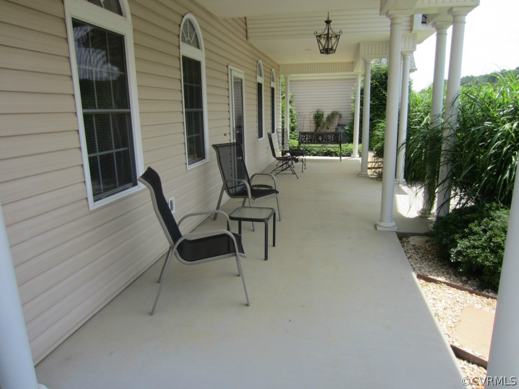 600 Three Chopt Road Manakin-Sabot, VA 23103 - Photo 22 of 24 a view of a patio with table and chairs and potted plants