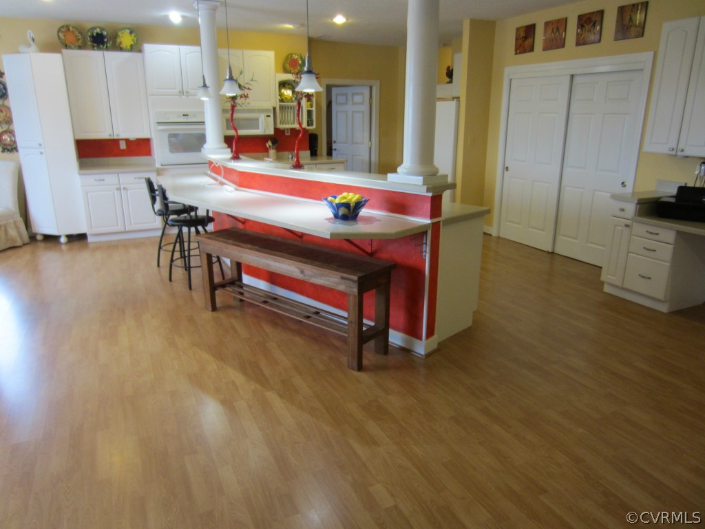 600 Three Chopt Road Manakin-Sabot, VA 23103 - Photo 2 of 24 a living room with kitchen island furniture and a wooden floor