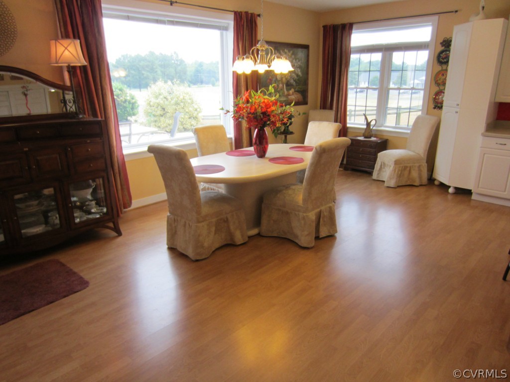600 Three Chopt Road Manakin-Sabot, VA 23103 - Photo 3 of 24 a living room with furniture a fireplace and a large window