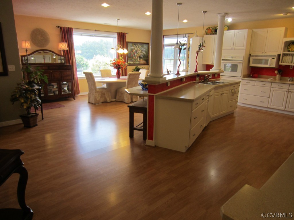 600 Three Chopt Road Manakin-Sabot, VA 23103 - Photo 6 of 24 a living room with furniture a wooden floor and a large window