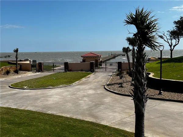 a view of a swimming pool with a patio and a yard