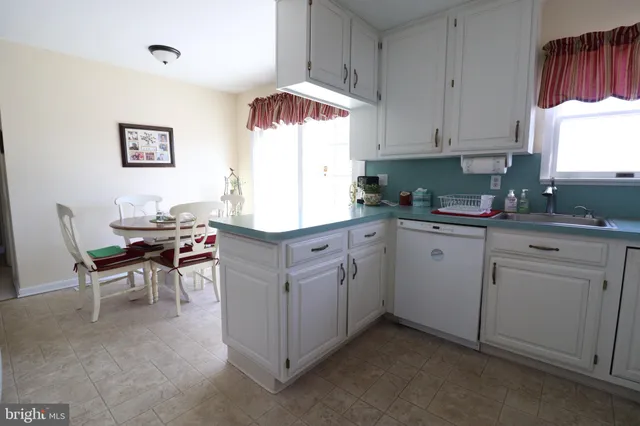 a kitchen with cabinets and white furniture