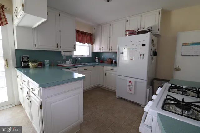 a kitchen with a sink stove and refrigerator