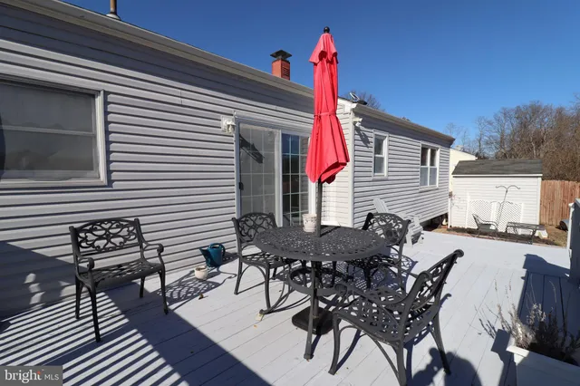a table and chairs in front of a house