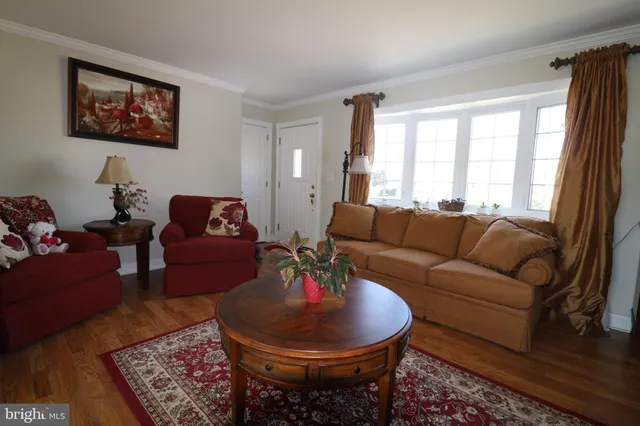 a living room with furniture a rug and a large window