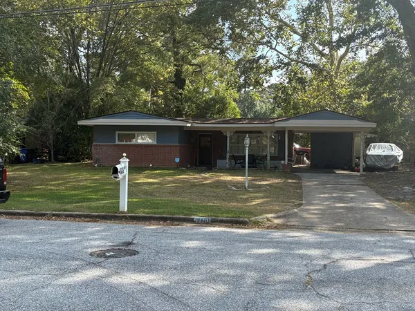 a front view of house with a garden