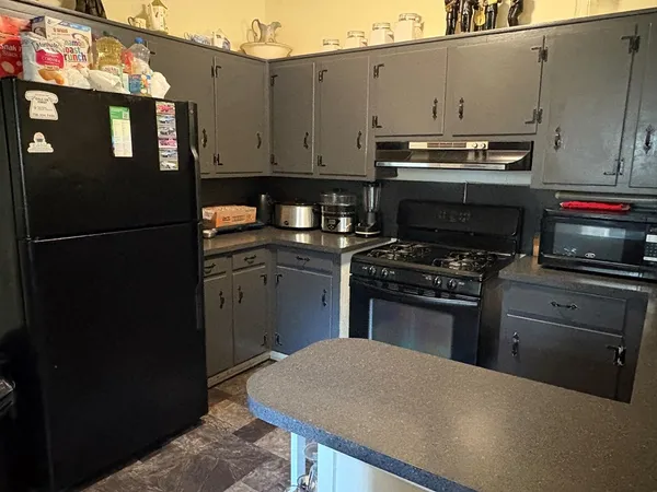a kitchen with a appliances and cabinets