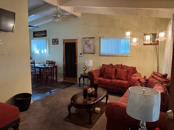 a living room with furniture and wooden floor