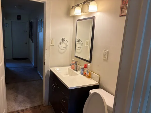 a bathroom with a sink vanity and a mirror
