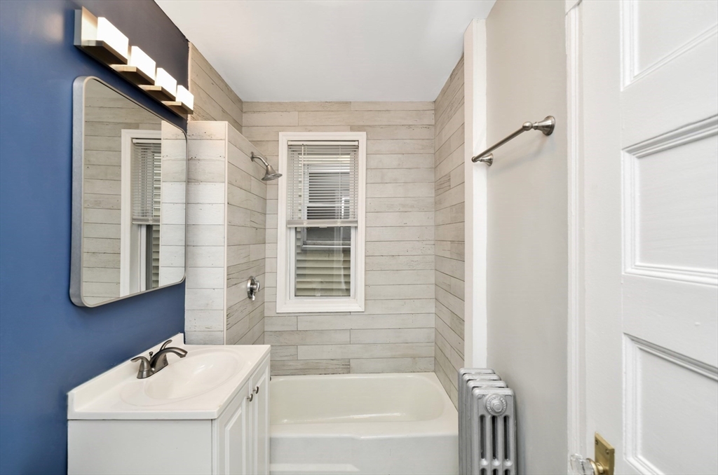 6 Coleman Street, Unit 2 Boston, MA 02125 - Photo 13 of 19 a bathroom with a sink a mirror and a bathtub