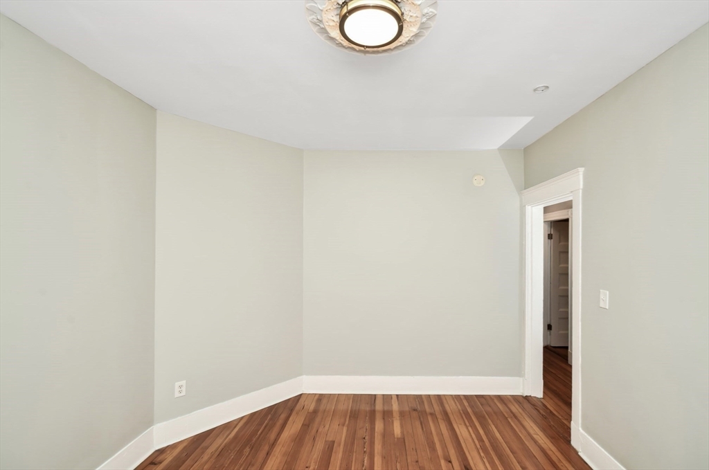 6 Coleman Street, Unit 2 Boston, MA 02125 - Photo 16 of 19 a view of a room with wooden floor and a white wall