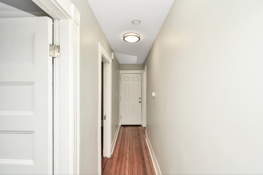 6 Coleman Street, Unit 2 Boston, MA 02125 - Photo 17 of 19 a view of a hallway with wooden floor