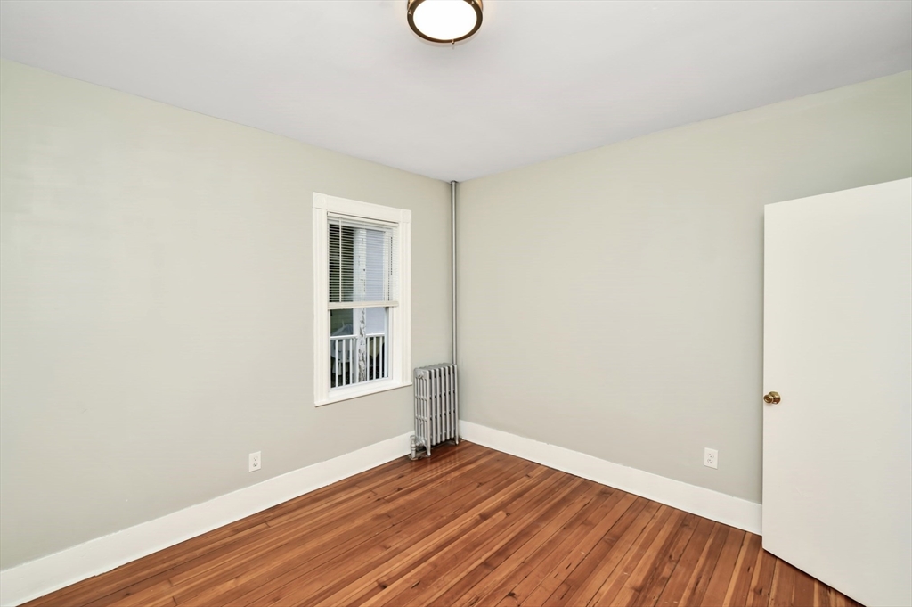 6 Coleman Street, Unit 2 Boston, MA 02125 - Photo 18 of 19 a view of an empty room with wooden floor and a window