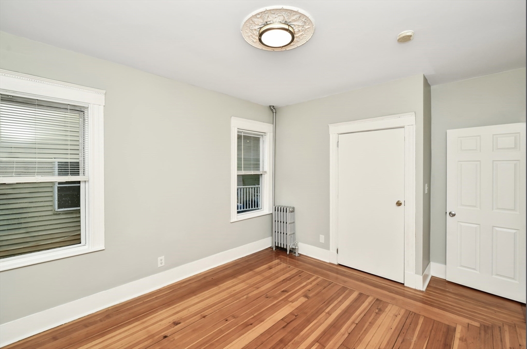 6 Coleman Street, Unit 2 Boston, MA 02125 - Photo 19 of 19 an empty room with wooden floor and windows