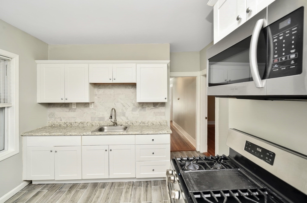 6 Coleman Street, Unit 2 Boston, MA 02125 - Photo 4 of 19 a kitchen with a sink stove and refrigerator