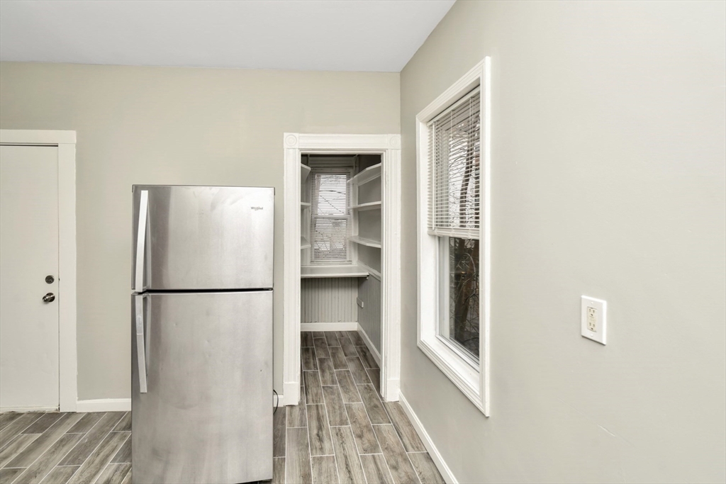 6 Coleman Street, Unit 2 Boston, MA 02125 - Photo 6 of 19 a white refrigerator freezer and a wooden floor
