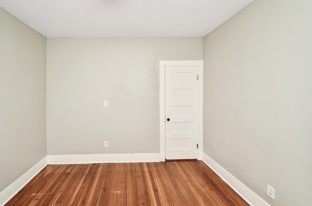 6 Coleman Street, Unit 2 Boston, MA 02125 - Photo 8 of 19 a view of an empty room with wooden floor