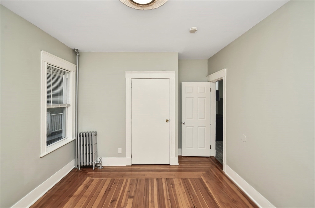 6 Coleman Street, Unit 2 Boston, MA 02125 - Photo 10 of 19 a view of a room with wooden floor and a window