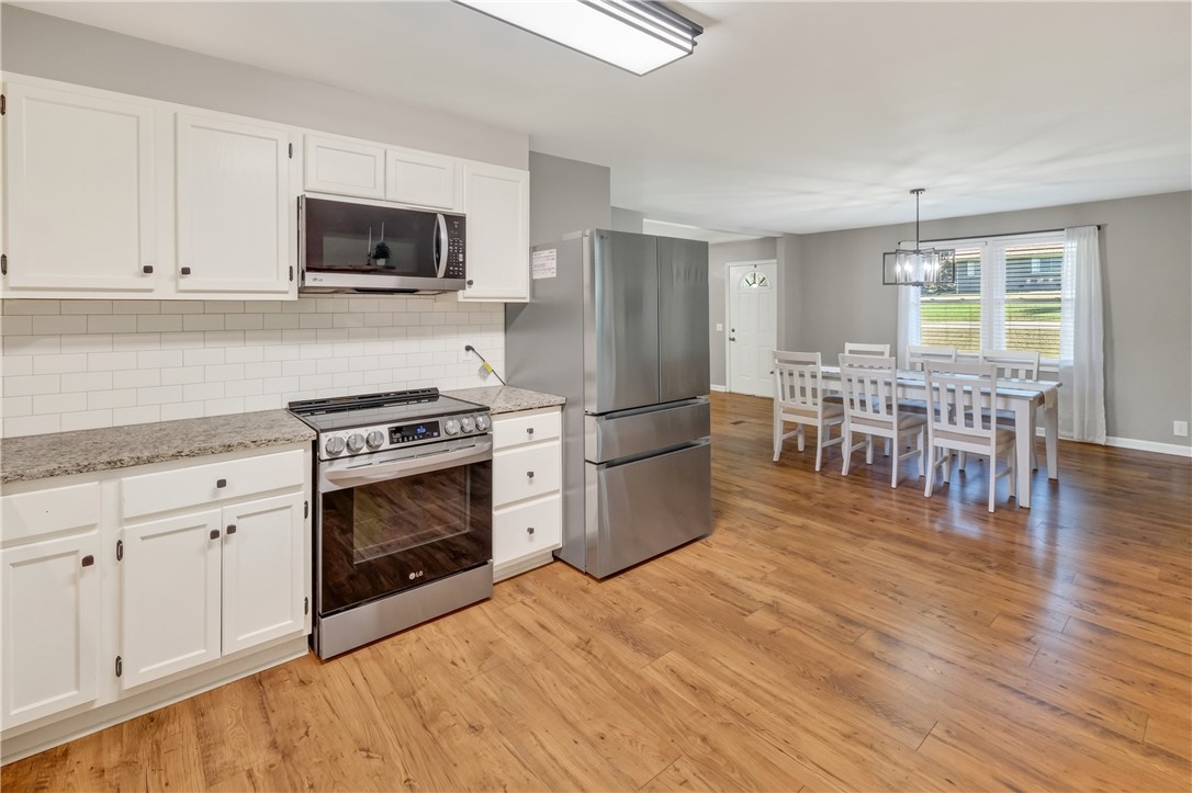 207 Ridgecrest Drive Williamston, SC 29697 - Photo 8 of 22 Gleaming wood floors anchor this open-concept culinary space flowing into the dining area.