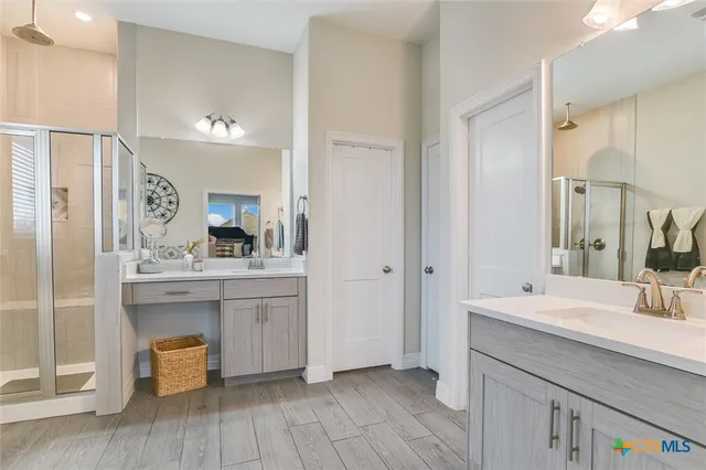 a bathroom with a double vanity sink mirror and toilet