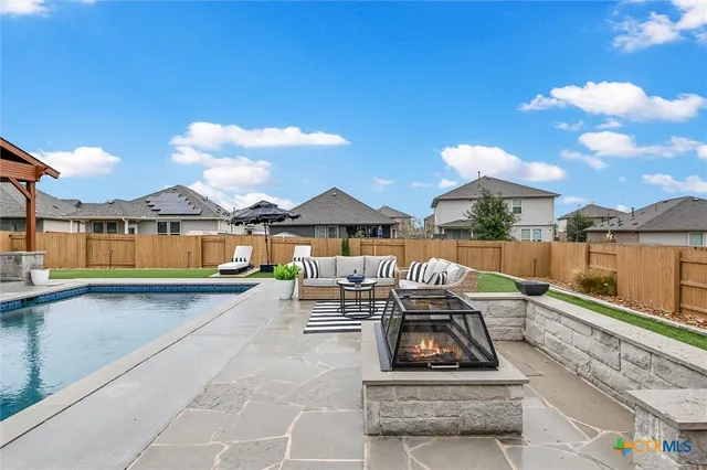 swimming pool view with a seating space