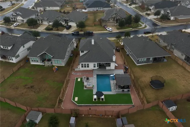 an aerial view of a house with a yard