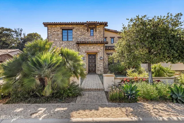 a front view of a house with garden