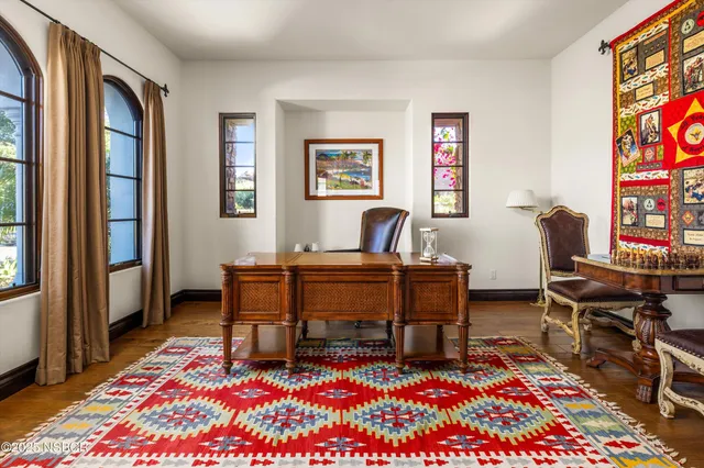 a room with pool table and windows