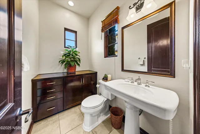 a kitchen with a sink and chairs