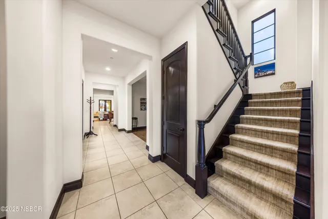 a living room with furniture a dining table and a refrigerator