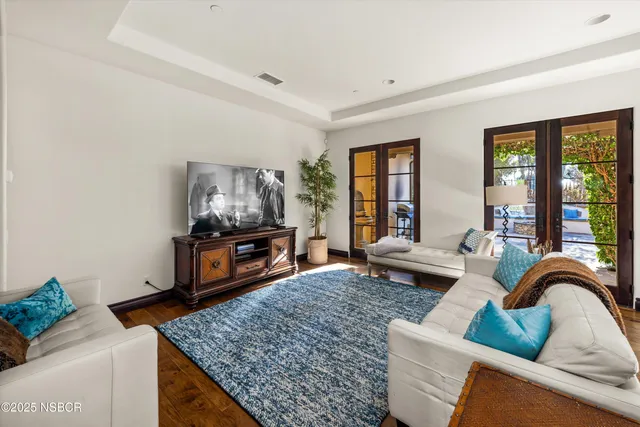 a bathroom with a tub a sink and a large mirror