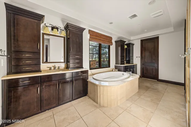 an outdoor space with patio lots of furniture and umbrella